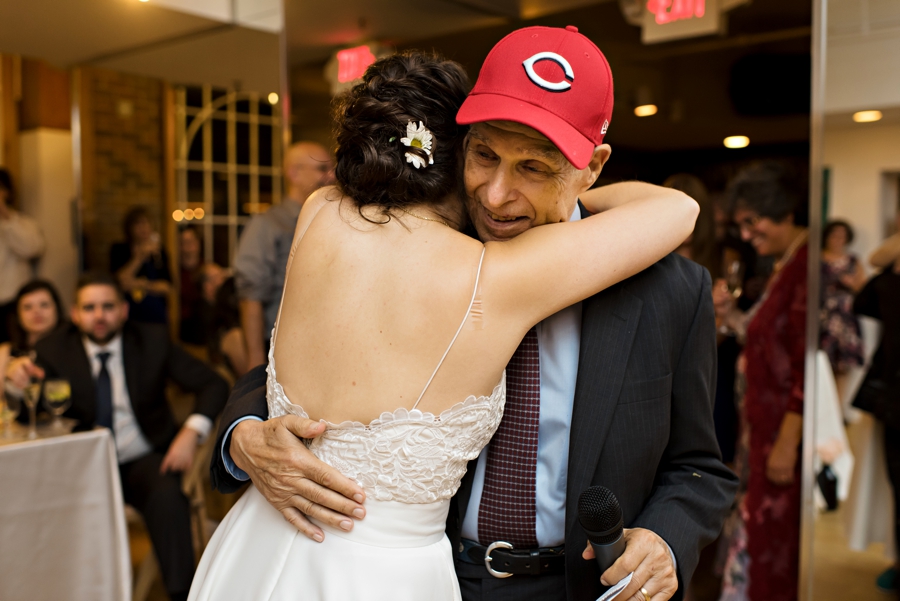 A bride hugs her grandfather after his speech.